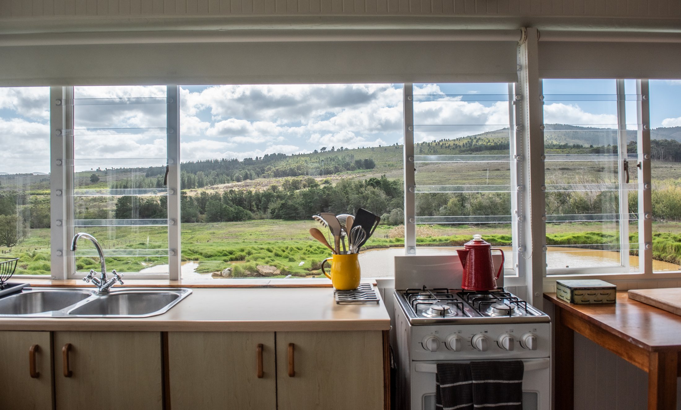 Duck Pond — kitchen with pond view at Landmeterskop Farm Cottages